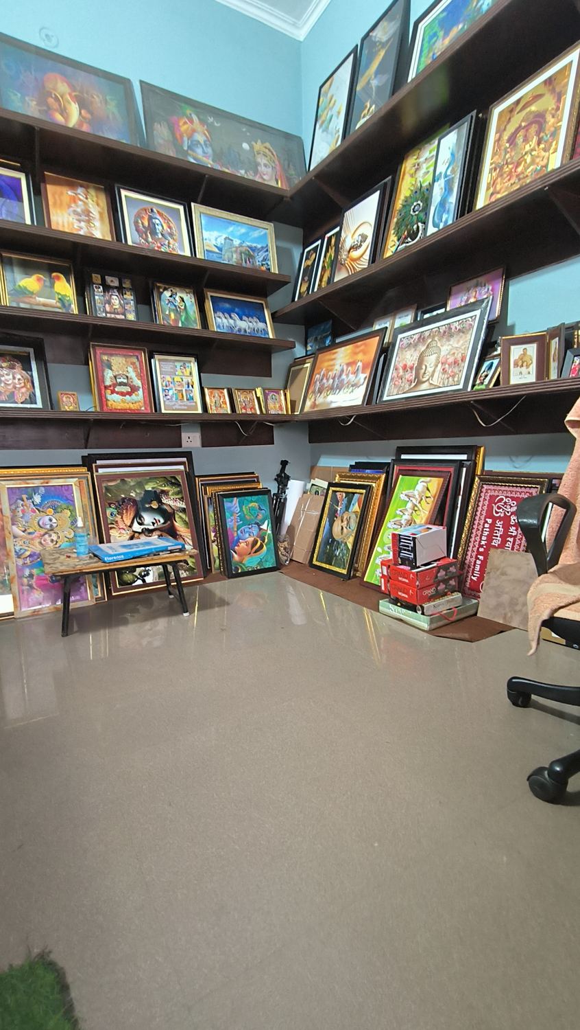 Inside SRIKRISHNA Photo Framing studio with framed artwork displayed on shelves